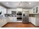 A well-lit kitchen featuring stainless steel appliances, ample white cabinetry, and granite countertops, perfect for culinary enthusiasts at 3025 Greenfield Dr, Marietta, GA 30068