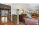 Spacious living room with hardwood floors, a decorative stone half-wall and seamless access to the dining area at 3025 Greenfield Dr, Marietta, GA 30068