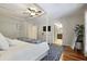 Serene main bedroom featuring hardwood floors, a four-poster bed, and calming decor, creating a restful atmosphere at 3025 Greenfield Dr, Marietta, GA 30068