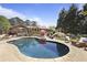 Sparkling pool surrounded by a large patio with lounge chairs and lush landscaping at 3025 Greenfield Dr, Marietta, GA 30068
