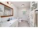 Bathroom featuring a marble countertop, white cabinets and beach themed decor at 489 Warrenton Dr, Douglasville, GA 30134