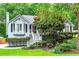 Inviting home with a white picket fence and lush, colorful landscaping at 489 Warrenton Dr, Douglasville, GA 30134