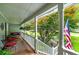 Covered front porch with swing, ample seating, and a lovely garden view at 489 Warrenton Dr, Douglasville, GA 30134