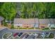 Aerial view showcasing the townhome community with lush landscaping, parking, and mature trees at 1038 Huntcliff, Atlanta, GA 30350