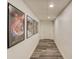 Basement hallway with gray laminate flooring and movie posters hanging on the wall at 1038 Huntcliff, Atlanta, GA 30350