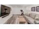 Basement living room area with a mounted flatscreen and gray, neutral-tone decor at 1038 Huntcliff, Atlanta, GA 30350