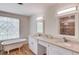 Bright bathroom with a standalone tub, double vanity, and decorative window, creating a relaxing and functional space at 1038 Huntcliff, Atlanta, GA 30350