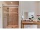 Modern bathroom with a glass-enclosed shower, vanity area, and neutral tiles, combining functionality with contemporary style at 1038 Huntcliff, Atlanta, GA 30350