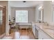 Serene bathroom with a standalone tub, double vanity, and decorative window, offering a relaxing and stylish space at 1038 Huntcliff, Atlanta, GA 30350