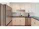 Well-lit kitchen with white cabinetry, stainless steel appliances, and herringbone tile backsplash at 1038 Huntcliff, Atlanta, GA 30350