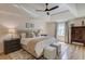 Inviting bedroom featuring a tray ceiling, hardwood floors, and neutral tones, creating a serene and stylish retreat at 1038 Huntcliff, Atlanta, GA 30350