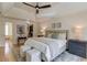 Bright bedroom featuring a tray ceiling, hardwood floors, and neutral tones, complemented by an ensuite bathroom and a walk-in closet at 1038 Huntcliff, Atlanta, GA 30350