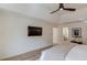 Spacious bedroom featuring hardwood floors, neutral tones, and a modern TV, creating a comfortable and stylish retreat at 1038 Huntcliff, Atlanta, GA 30350