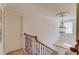 Elegant staircase featuring an iron-spindled railing and decorative chandelier, enhancing the home's classic charm at 1038 Huntcliff, Atlanta, GA 30350