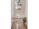 Bright staircase featuring an iron-spindled railing, hardwood steps, and a decorative chandelier, creating an elegant transition between floors at 1038 Huntcliff, Atlanta, GA 30350
