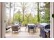 A wood deck with outdoor seating and a grill provides a perfect entertaining space overlooking the backyard at 1295 Lindenwood Ne Ln, Brookhaven, GA 30319