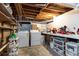 Utility basement area with washer, dryer, storage shelves, and work bench at 1295 Lindenwood Ne Ln, Brookhaven, GA 30319