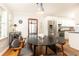 Sunlit dining area features a modern table set, updated appliances, and access to outdoor porch at 1295 Lindenwood Ne Ln, Brookhaven, GA 30319