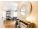 Stylish foyer with a wooden console table, round mirror, and hardwood flooring at 1295 Lindenwood Ne Ln, Brookhaven, GA 30319