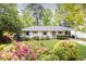 Charming brick home with a well-maintained front yard and colorful azalea bushes at 1295 Lindenwood Ne Ln, Brookhaven, GA 30319