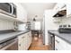Charming kitchen with white cabinetry, stainless steel appliances, and dark countertops at 1295 Lindenwood Ne Ln, Brookhaven, GA 30319