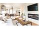 Comfortable living room features hardwood floors, a modern fireplace, and an open view of the dining and kitchen areas at 1295 Lindenwood Ne Ln, Brookhaven, GA 30319