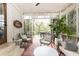 Relaxing screened porch with outdoor seating, a ceiling fan, and a brick accent wall at 1295 Lindenwood Ne Ln, Brookhaven, GA 30319