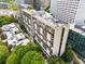 Aerial view of the building and surrounding neighborhood featuring green trees and city views at 145 15Th Ne St # 435, Atlanta, GA 30309