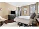 Spacious bedroom featuring a large bed, dark wood flooring and balcony access at 145 15Th Ne St # 435, Atlanta, GA 30309