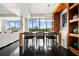 Bright dining room with dark wood floors, modern table set, built-in shelving, and lots of natural light at 145 15Th Ne St # 435, Atlanta, GA 30309
