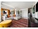 Open-concept living room featuring a modern sofa, colorful rug, and a view of the stairs at 145 15Th Ne St # 435, Atlanta, GA 30309