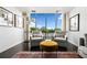 Bright living room featuring large window, two chairs, accent rug, ottoman, and decorative artwork at 145 15Th Ne St # 435, Atlanta, GA 30309