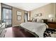 Comfortable bedroom with wood floors and natural light coming from balcony access at 145 15Th Ne St # 435, Atlanta, GA 30309