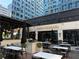 Chic outdoor patio with stylish seating, fire pit, and the 'Saints + Council' sign at 145 15Th Ne St # 435, Atlanta, GA 30309