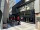 Outside view of a restaurant/food hall with outdoor seating and lush landscaping at 145 15Th Ne St # 435, Atlanta, GA 30309