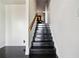 Modern staircase featuring dark wood steps and a light wood handrail leading to the upper level at 145 15Th Ne St # 435, Atlanta, GA 30309