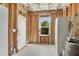 Unfinished basement with exposed beams, concrete floor, door, and window at 244 Walnut Ridge Rd, Canton, GA 30115