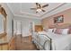 Primary bedroom with hardwood floors, neutral paint, and a decorative tray ceiling at 244 Walnut Ridge Rd, Canton, GA 30115