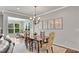 Dining room with hardwood floors, charming chandelier, and view of the sunroom at 244 Walnut Ridge Rd, Canton, GA 30115
