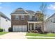 Charming two-story brick home with a manicured lawn and inviting front porch at 244 Walnut Ridge Rd, Canton, GA 30115