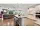 Open-concept kitchen featuring a large island, granite countertops, and stainless steel appliances at 244 Walnut Ridge Rd, Canton, GA 30115
