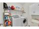 Well-organized laundry room with modern washer and dryer, storage shelving, and utility sink at 244 Walnut Ridge Rd, Canton, GA 30115