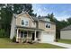 Charming two-story home with a manicured lawn, a covered front porch, and attached two car garage at 2706 Sw Riverpine Lot 176 Sw Trl, Atlanta, GA 30331