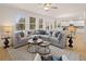 Spacious living room with large windows, ample seating, and an open layout, ideal for relaxation and entertaining guests at 2706 Sw Riverpine Lot 176 Sw Trl, Atlanta, GA 30331