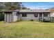 View of backyard featuring a small deck area and ample green space at 285 Independence Dr, Jonesboro, GA 30238