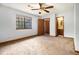 Bedroom with ceiling fan, one window, carpeted floor, and bathroom access at 285 Independence Dr, Jonesboro, GA 30238