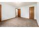 A cozy bedroom featuring neutral carpeting and two convenient access doors at 285 Independence Dr, Jonesboro, GA 30238