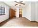 Bedroom with ceiling fan, one window, carpeted floor, bathroom, and closet access at 285 Independence Dr, Jonesboro, GA 30238