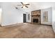 Open living room featuring a stone fireplace and ample natural light, creating a cozy atmosphere at 285 Independence Dr, Jonesboro, GA 30238
