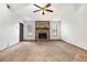 Spacious living room with a stone fireplace, neutral carpet, and abundant natural light from multiple windows at 285 Independence Dr, Jonesboro, GA 30238